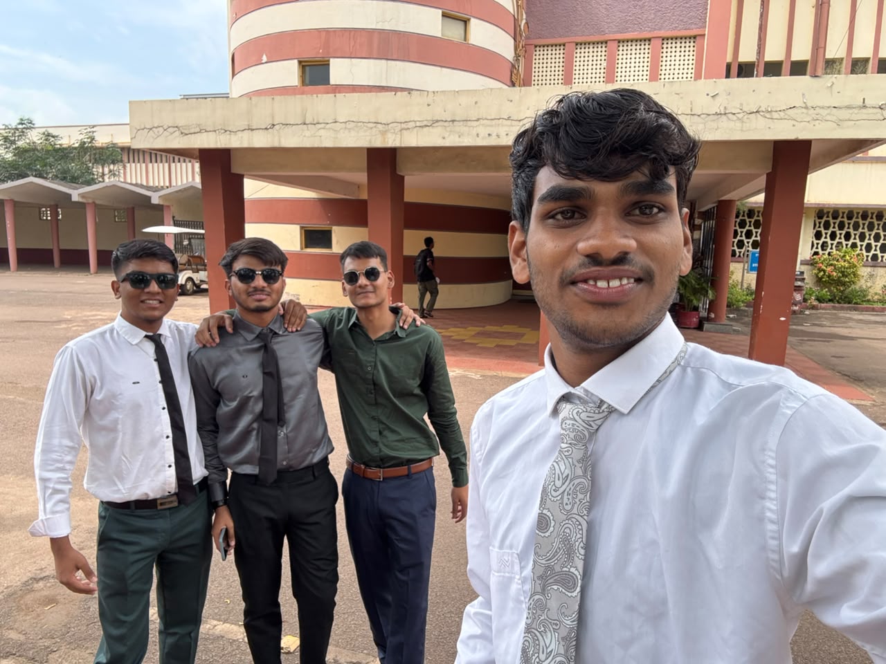 Roman Bharti with friends outside a campus building